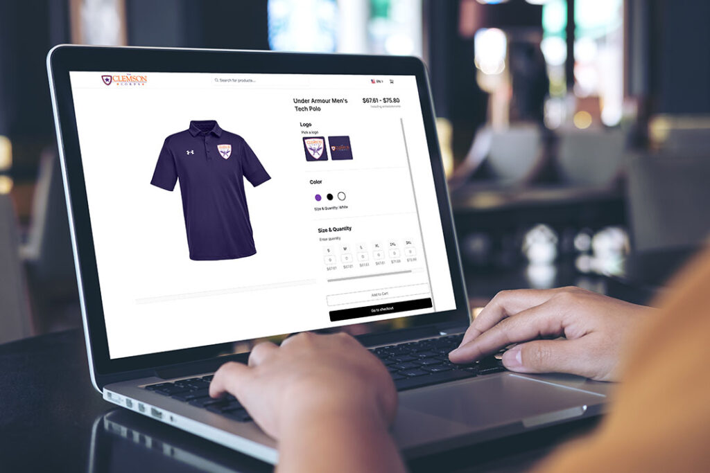 Person shopping online for a purple Under Armour polo shirt on a laptop.