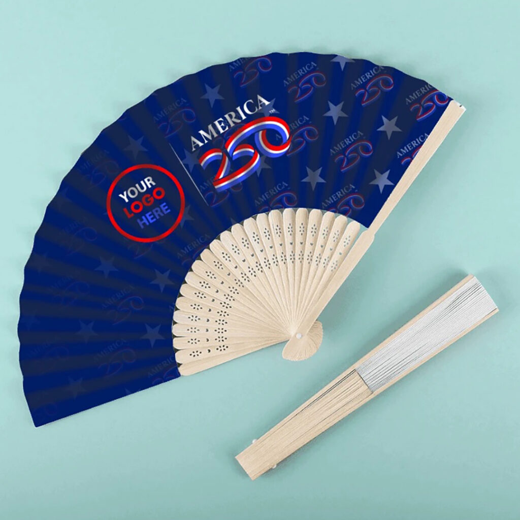 Blue “America 250” folding hand fan with star pattern and “Your Logo Here” circle, shown open and closed with a wooden handle on a light background.