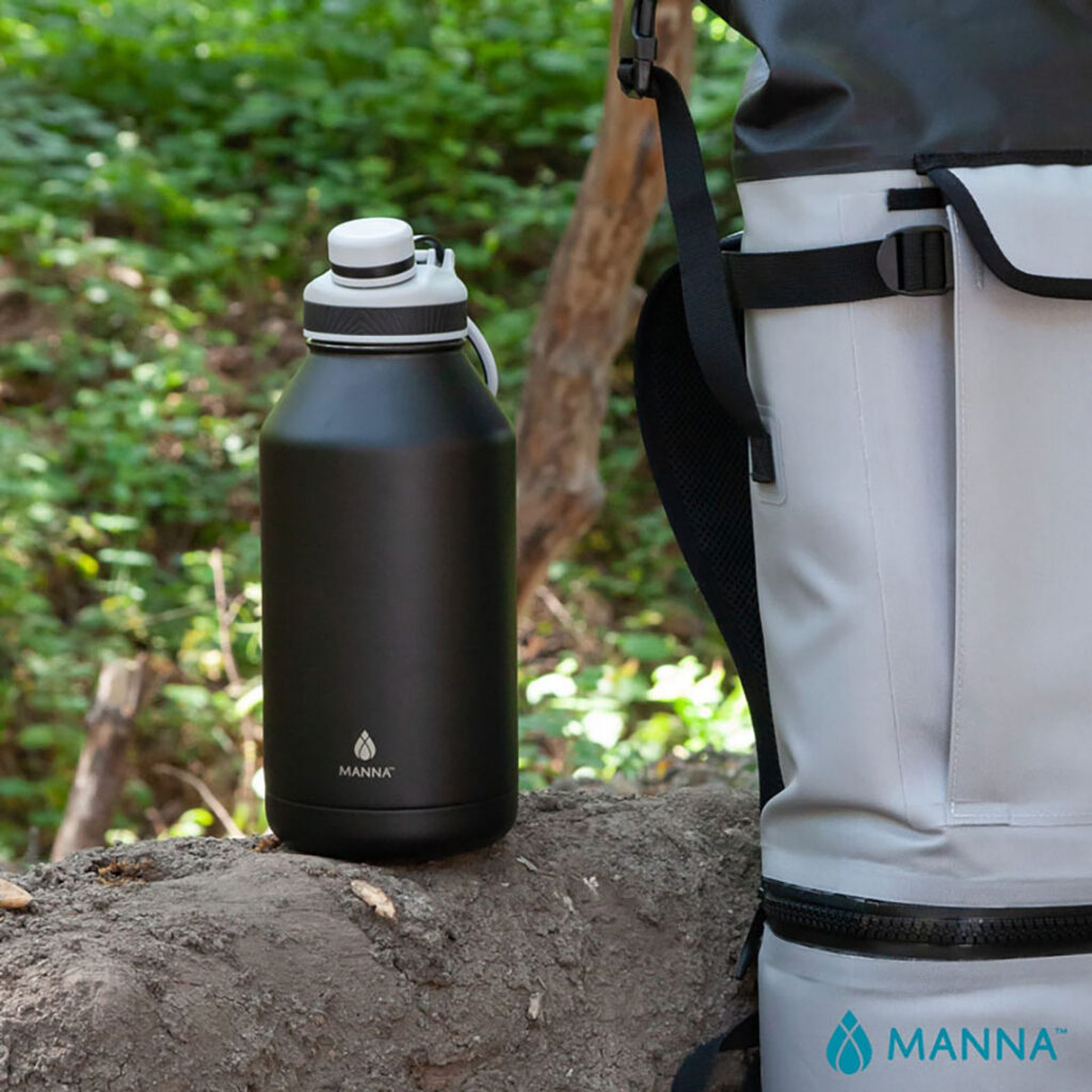 Large insulated water bottle and soft-sided cooler displayed outdoors, representing reusable branded drinkware and outdoor promotional products.