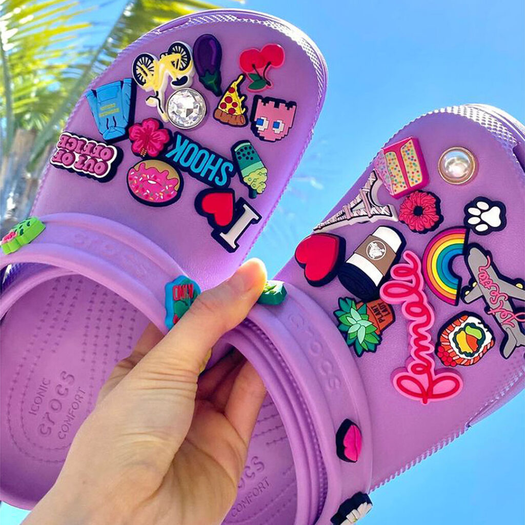 Customizable clogs with decorative charms, representing fashion accessories that recipients keep and personalize.