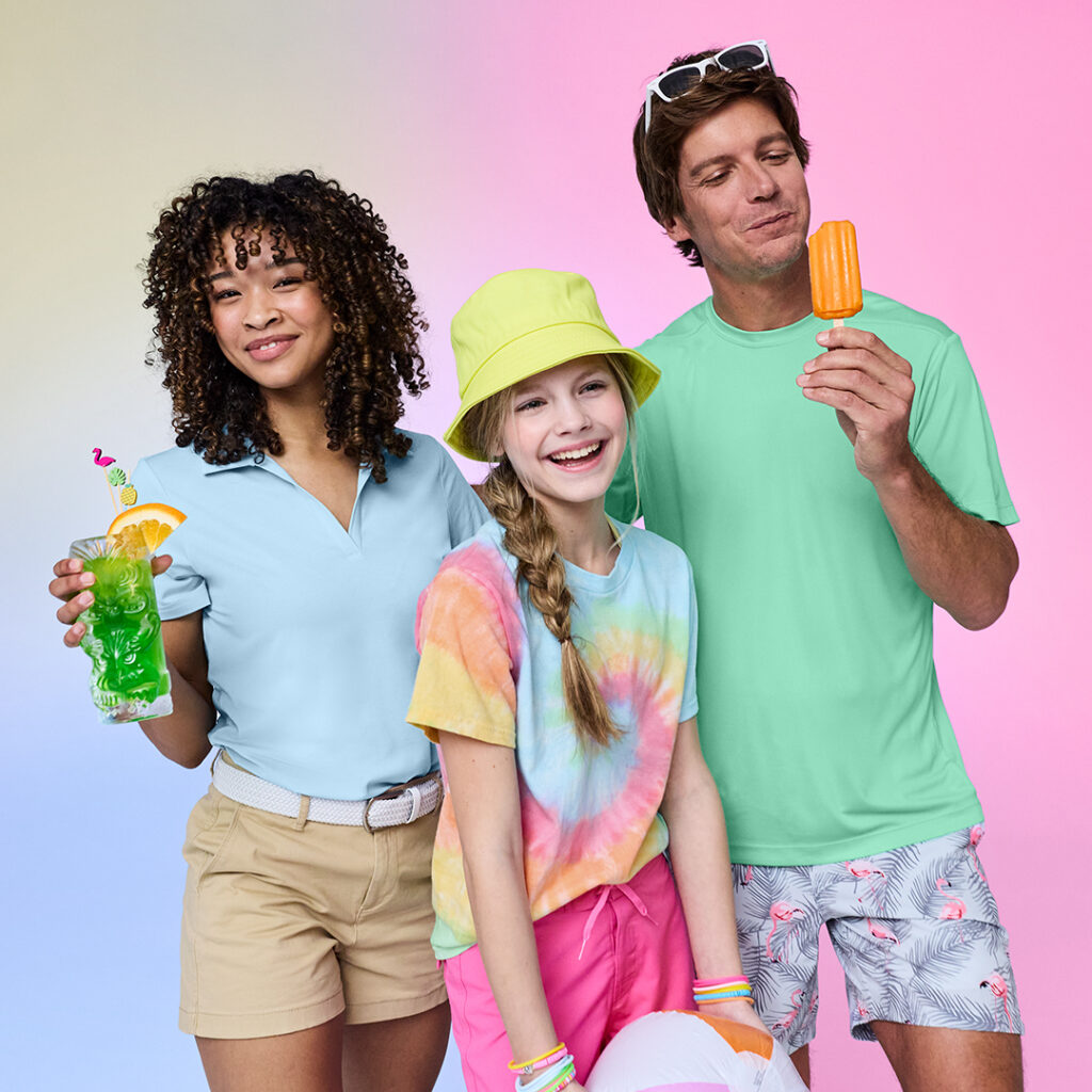 Visitors modeling colorful promotional apparel and enjoying branded refreshments, showcasing wearable tourism merchandise and souvenirs.