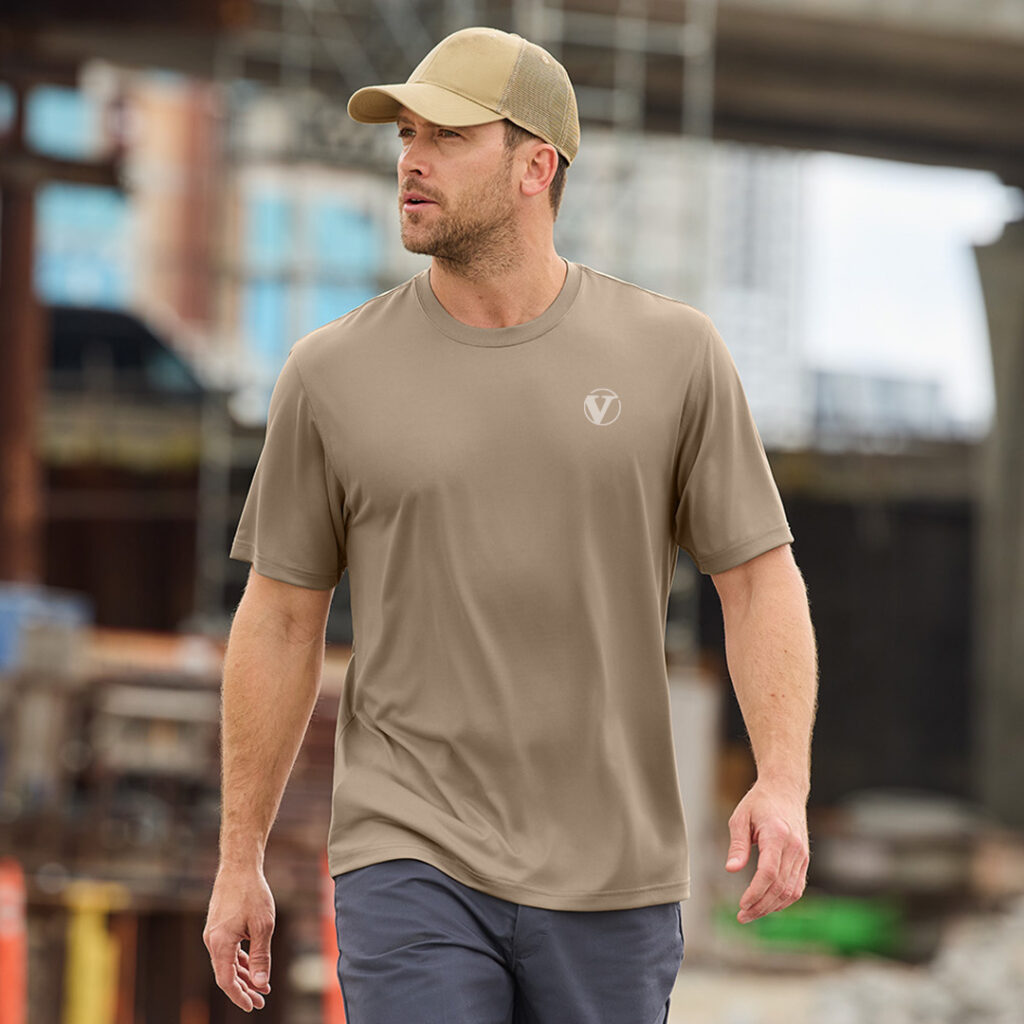 Custom branded nonprofit apparel worn at an outdoor worksite, highlighting performance clothing that strengthens organization visibility and supporter engagement.