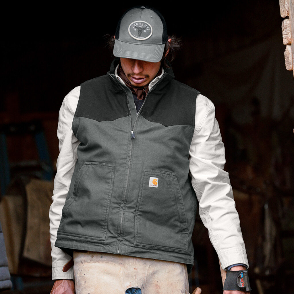 Individual wearing branded Carhartt workwear and cap, showcasing durable nonprofit apparel for volunteers and staff.