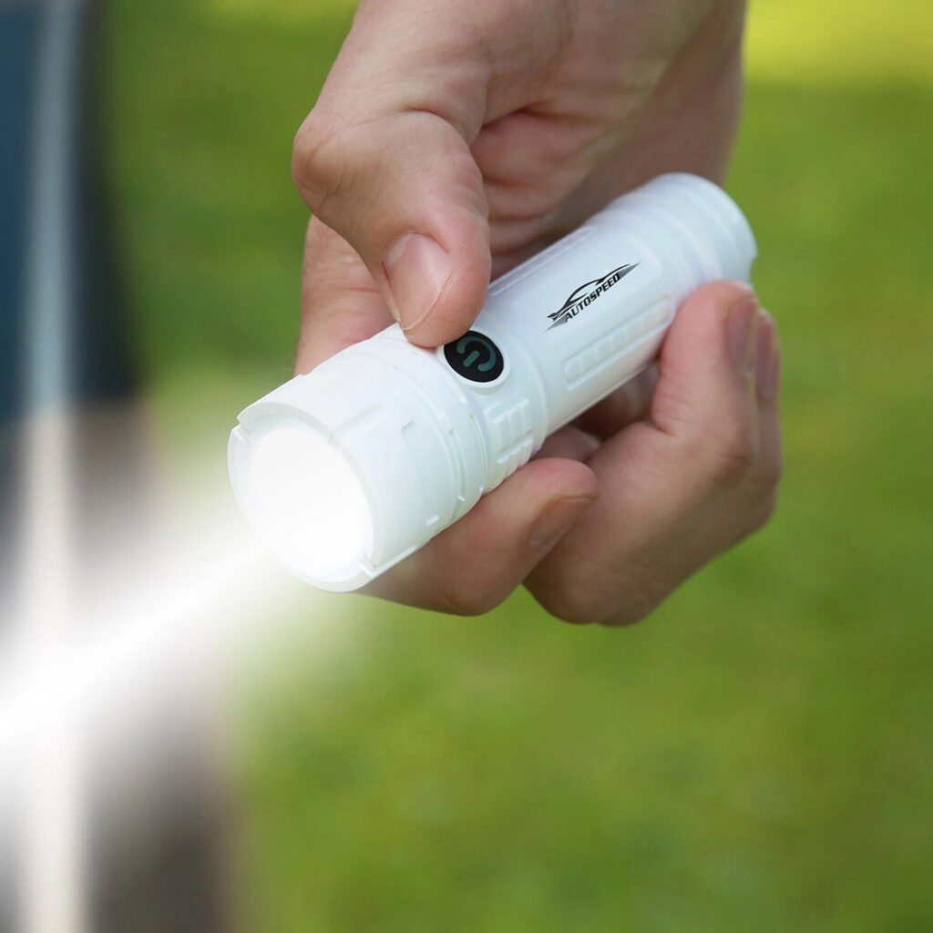 Compact branded rechargeable flashlight held in hand outdoors, representing useful tech-focused promotional merchandise for employees and clients.