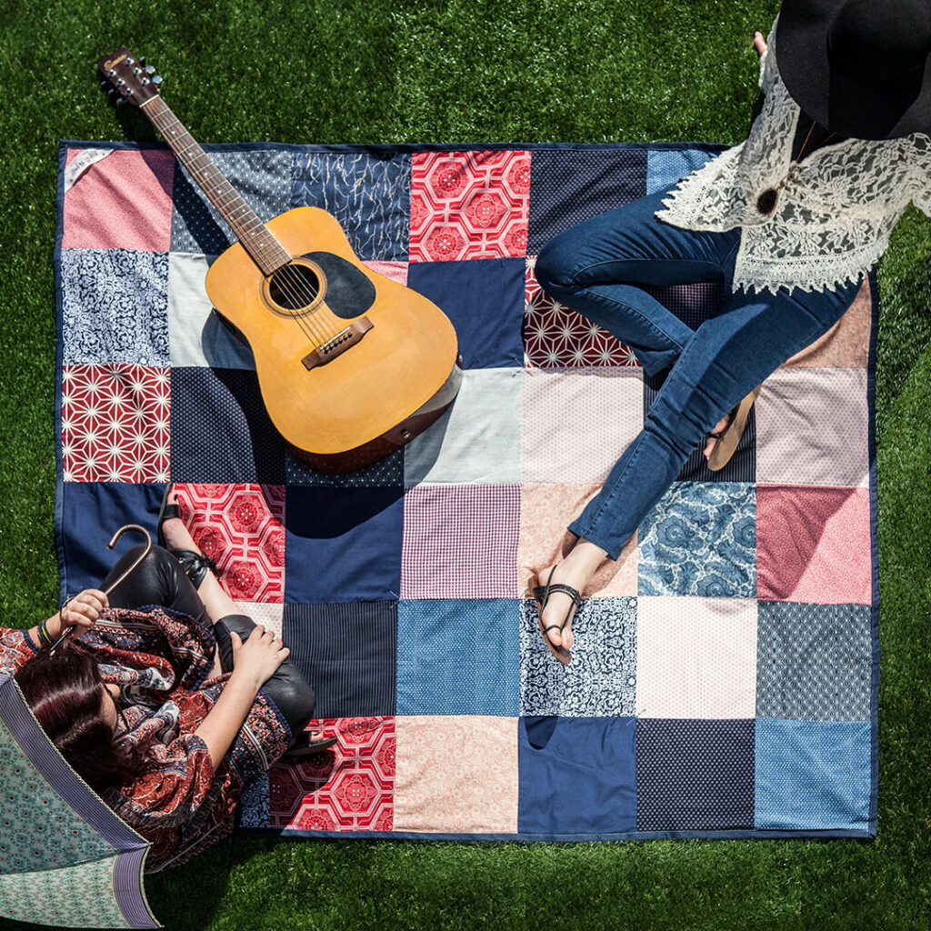 Large patchwork blanket used for outdoor recreation and picnics, highlighting how branded blankets combine practicality, comfort and promotional value.